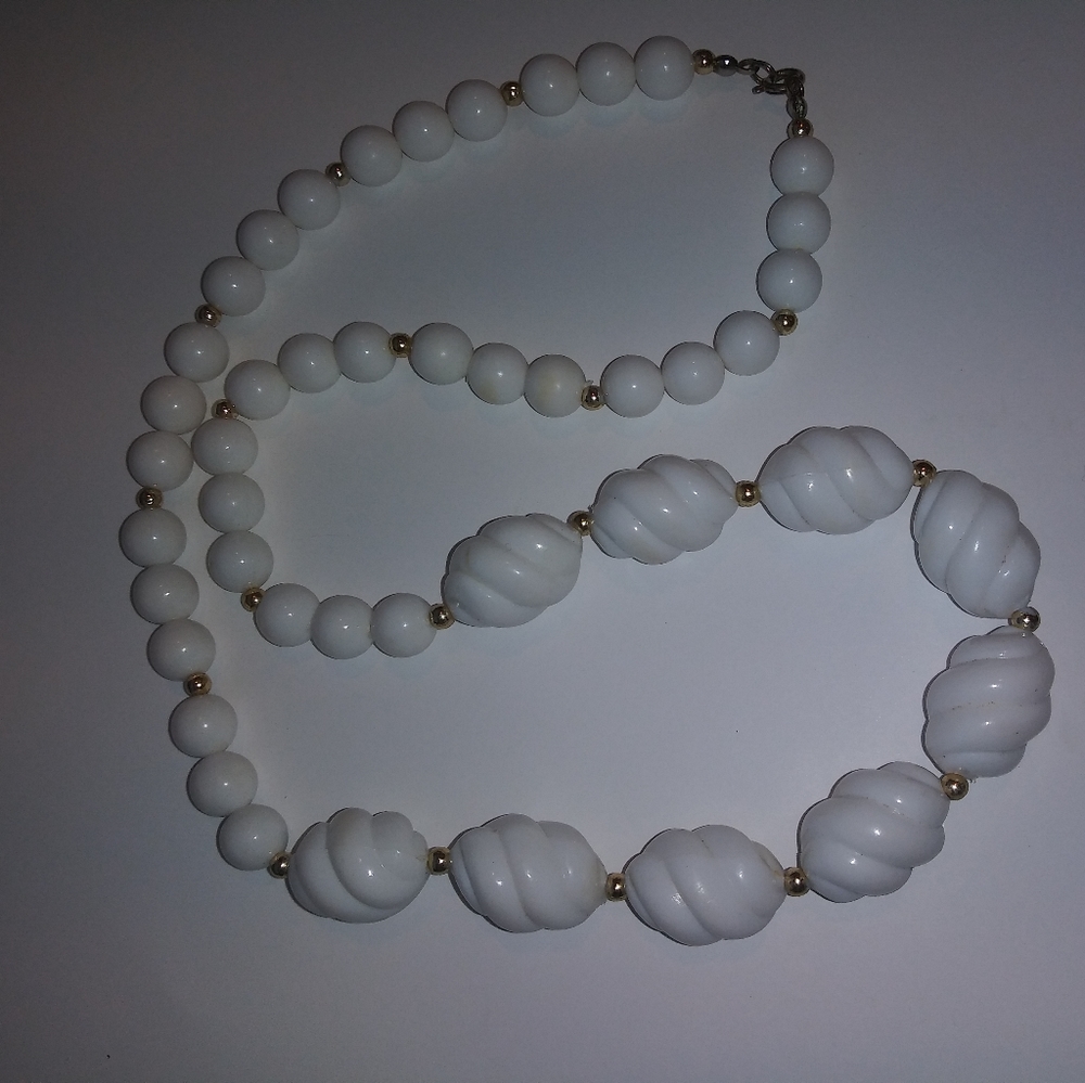 White plastic bead with gold spacers